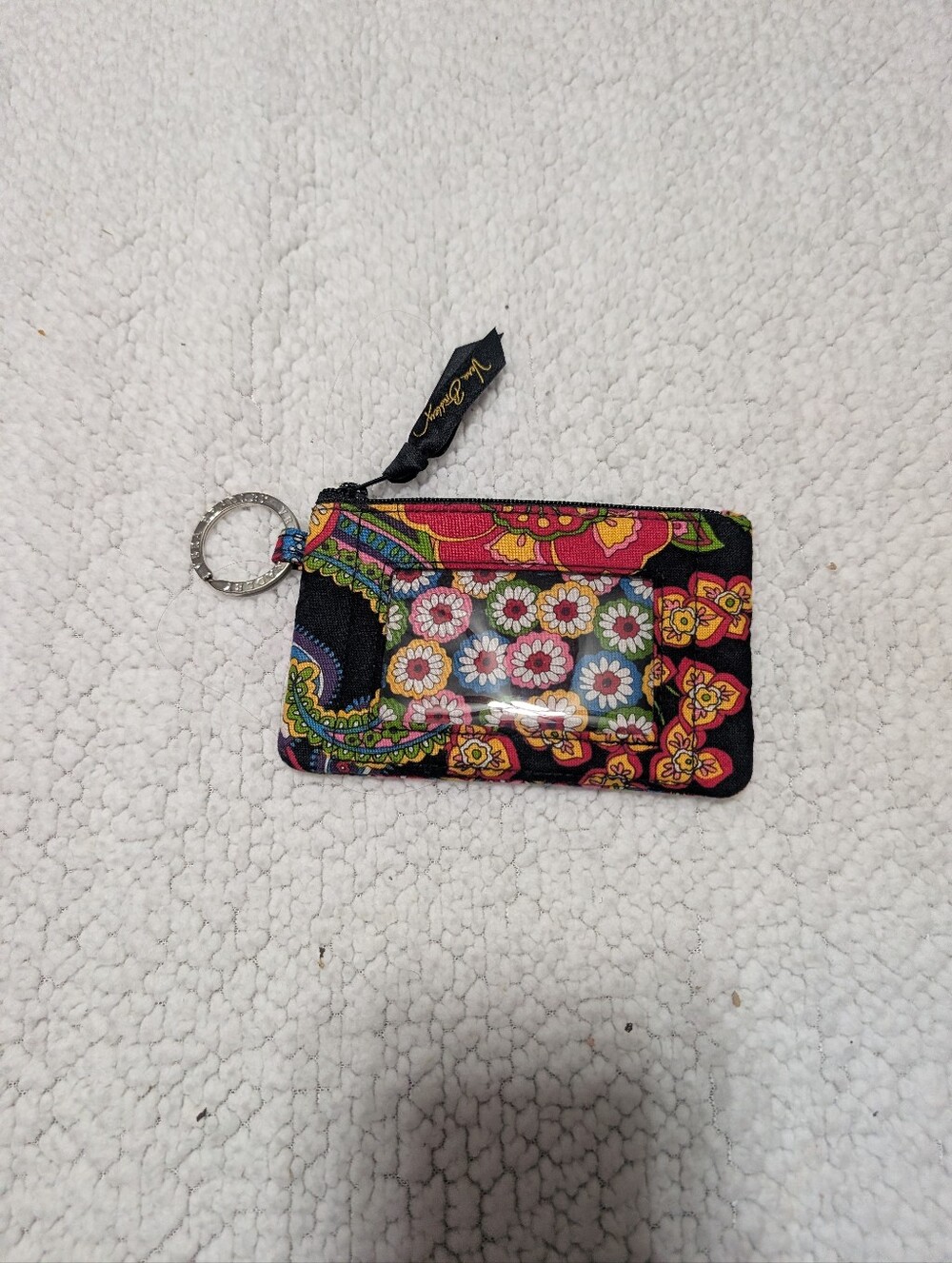Vera Bradley zip ID case features a vibrant paisley and floral pattern